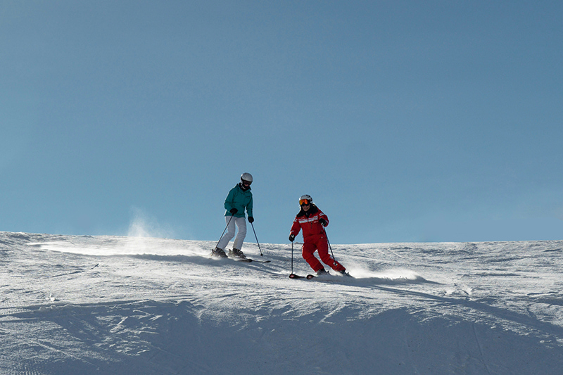 couple skiing on slopes