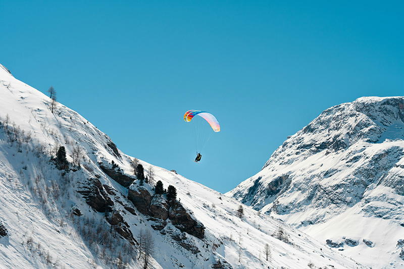 paragliding on snowy mountain