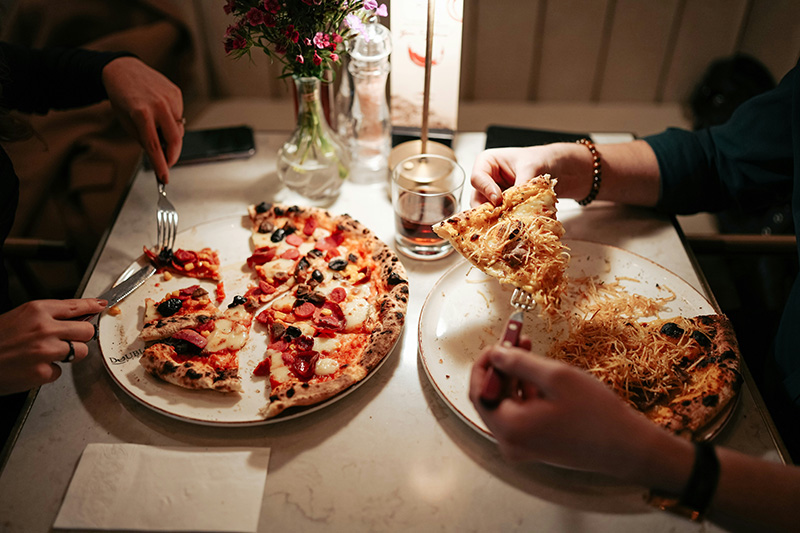 friends eating pizza and pasta